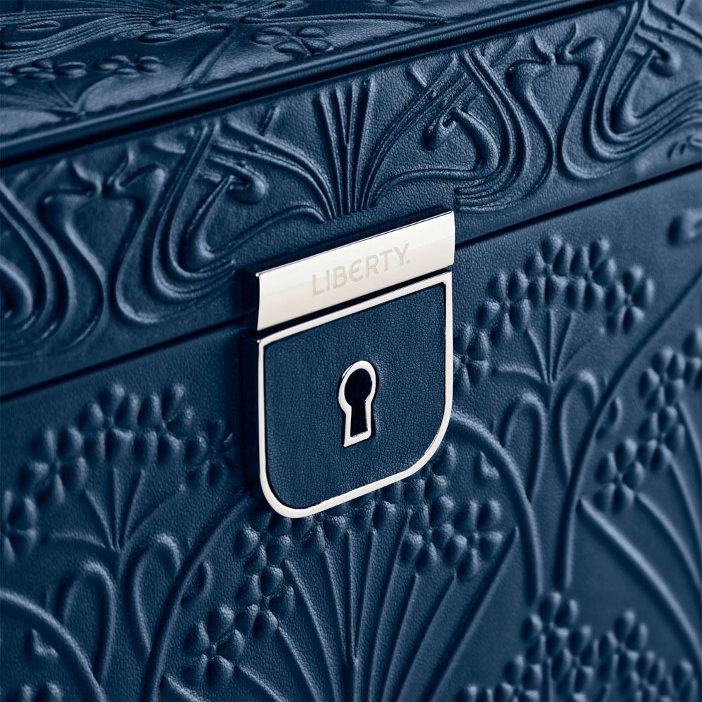Close-up of a blue textured box with a silver 'Liberty' lock emblem.