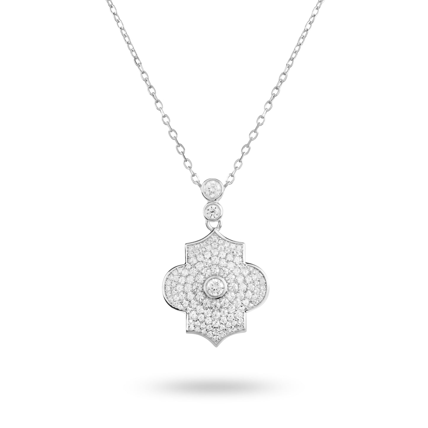 A white gold pave necklace with a pendant featuring a geometric architectural shape and intricate detailing, set on a plain background.