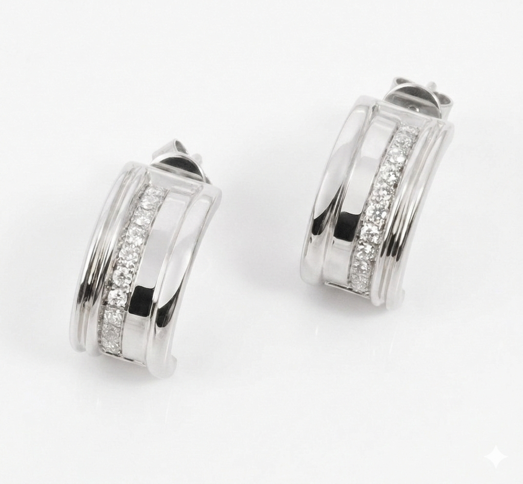 Pair of white gold hoop earrings with embedded white diamonds on a white background