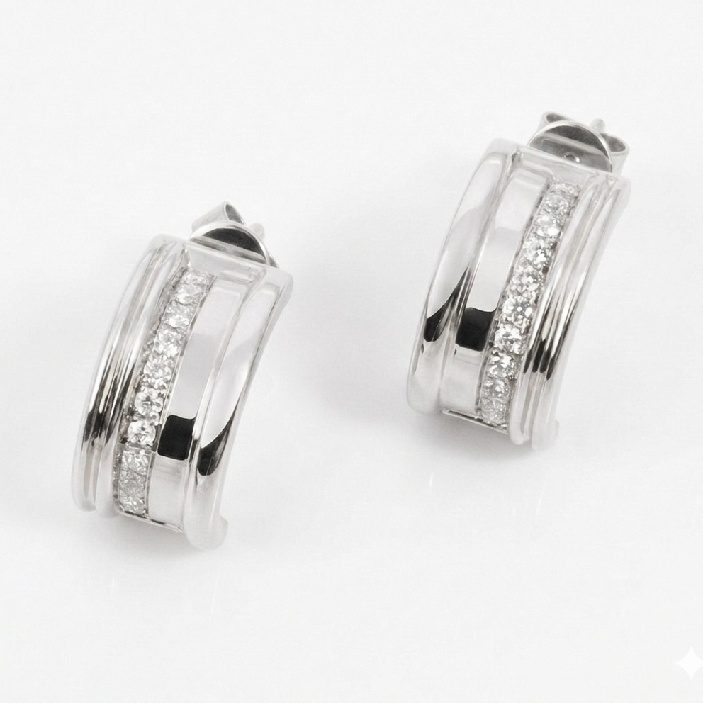 Pair of white gold hoop earrings with embedded white diamonds on a white background