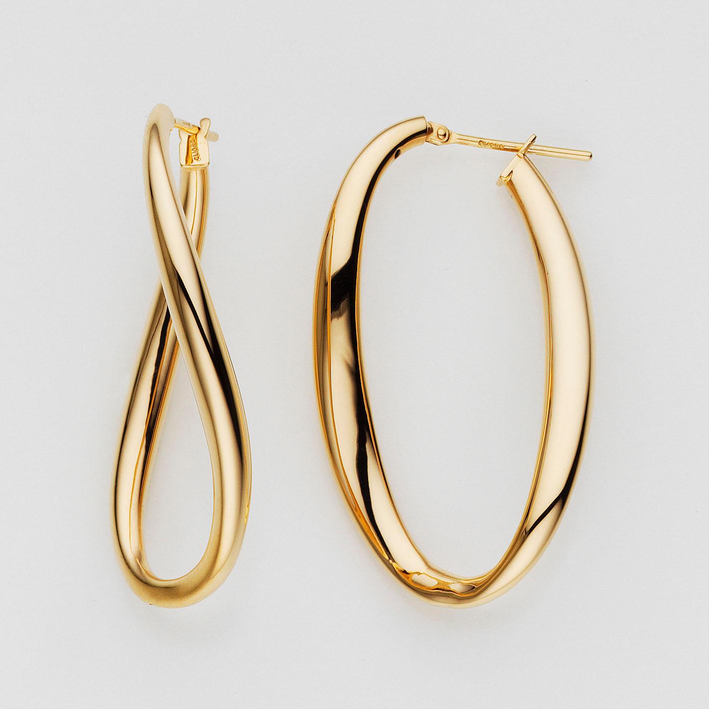 Gold hoop earrings on a light gray background