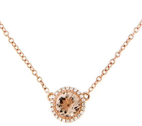 Rose gold necklace with a heart-shaped gemstone on a white background