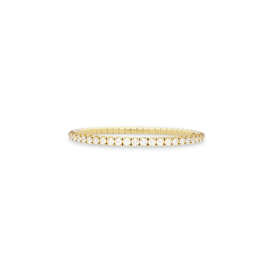 A thin yellow gold tennis bracelet with a single row of small clear gemstones, centered on a plain white background.