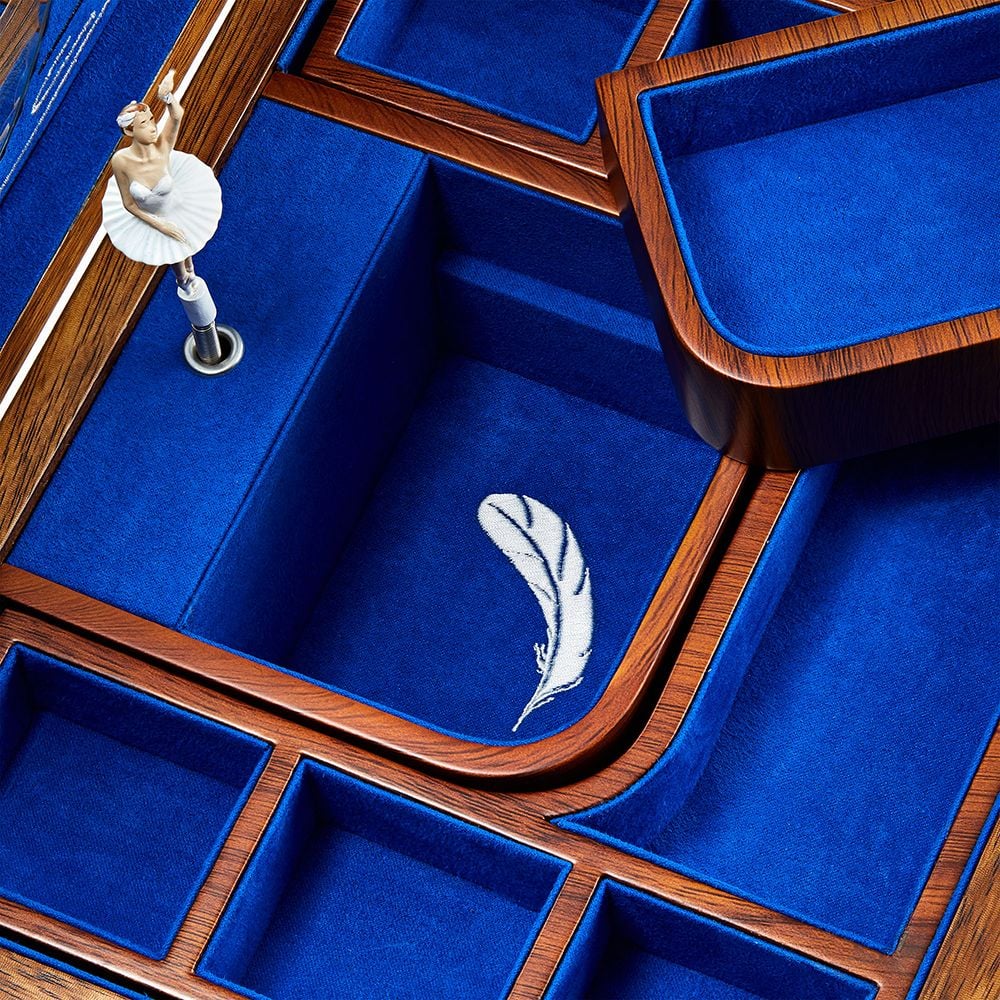 Wooden jewelry box with blue interior and decorative elements