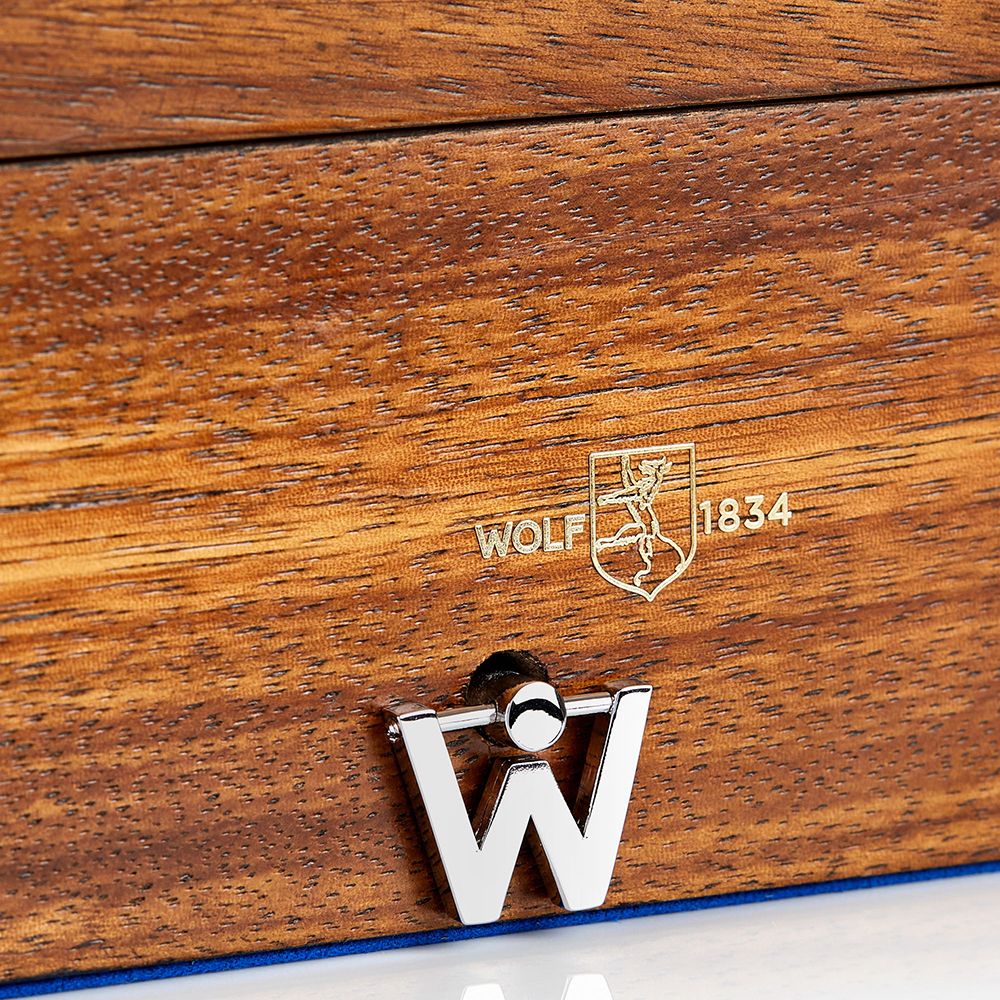 Wooden surface with 'Wolf 1834' logo and a metal 'W' emblem.