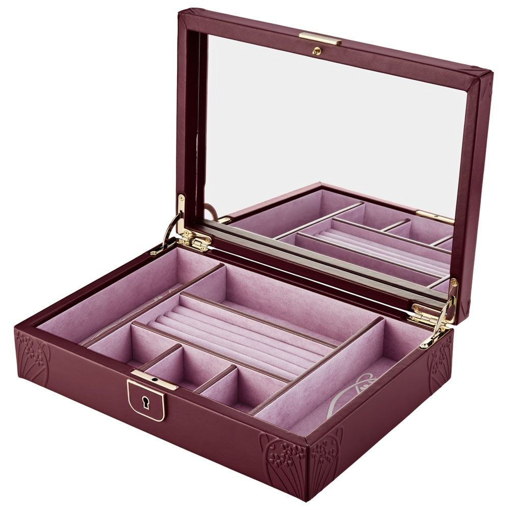 Jewelry box with pink interior and gold accents on a white background