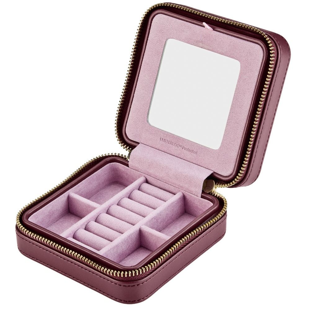 Pink jewelry box with mirror and ring compartments on a white background