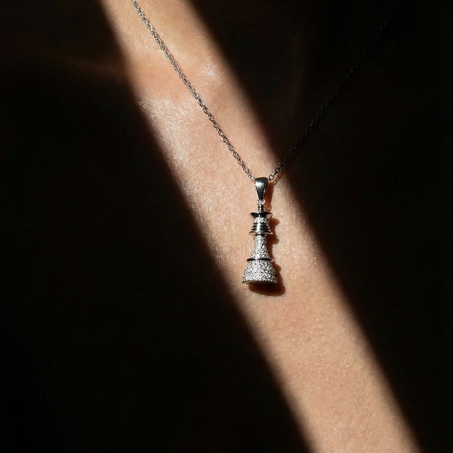 white gold white diamond chess queen necklace on a model 
