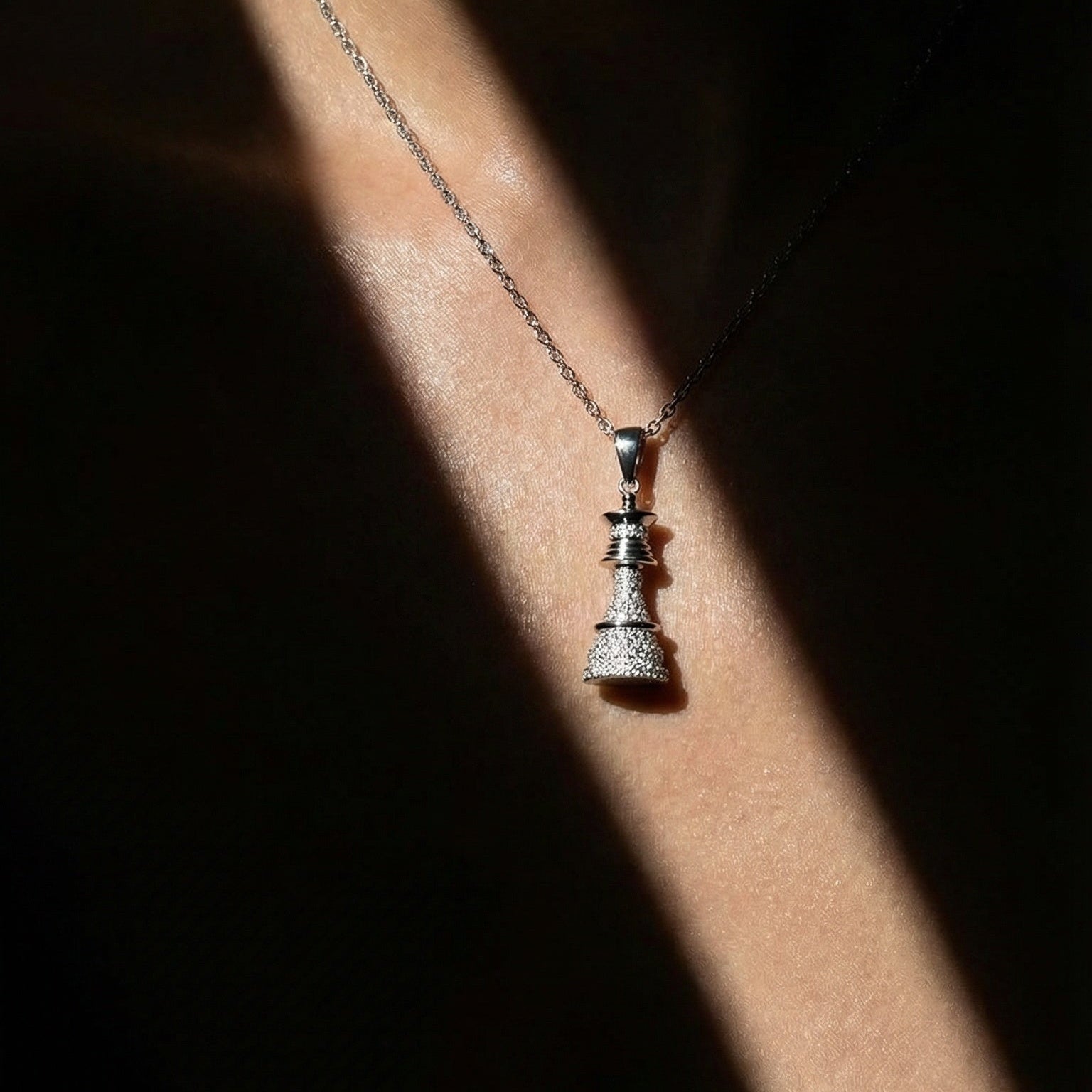 white gold white diamond chess queen necklace on a model 