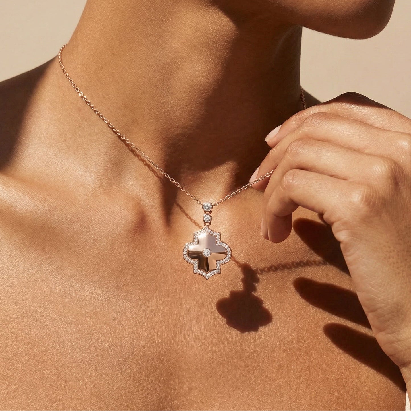 Necklace with a diamond pendant worn by a person against a neutral background