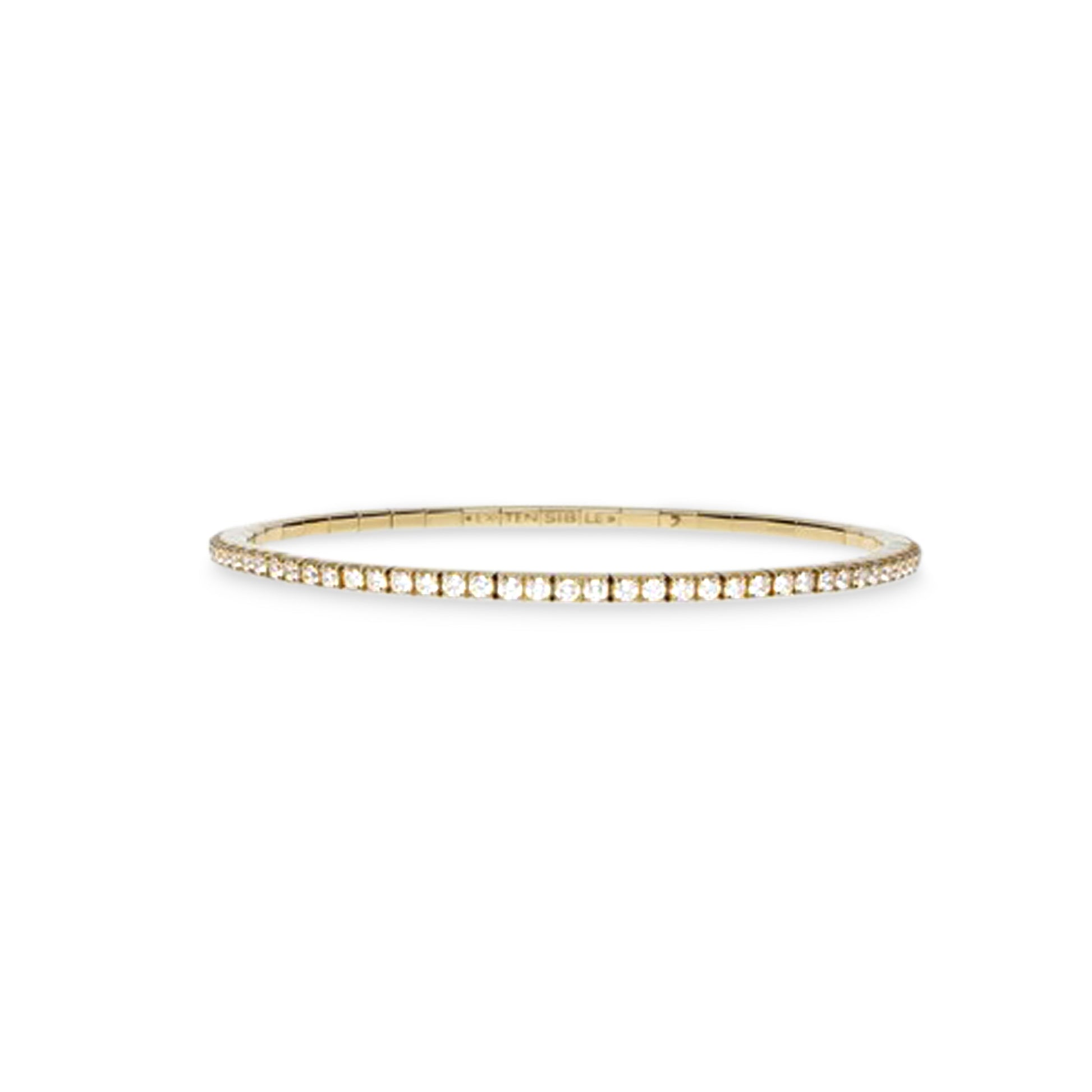 A delicate gold bangle bracelet with a single row of small clear stones, photographed against a solid white background.