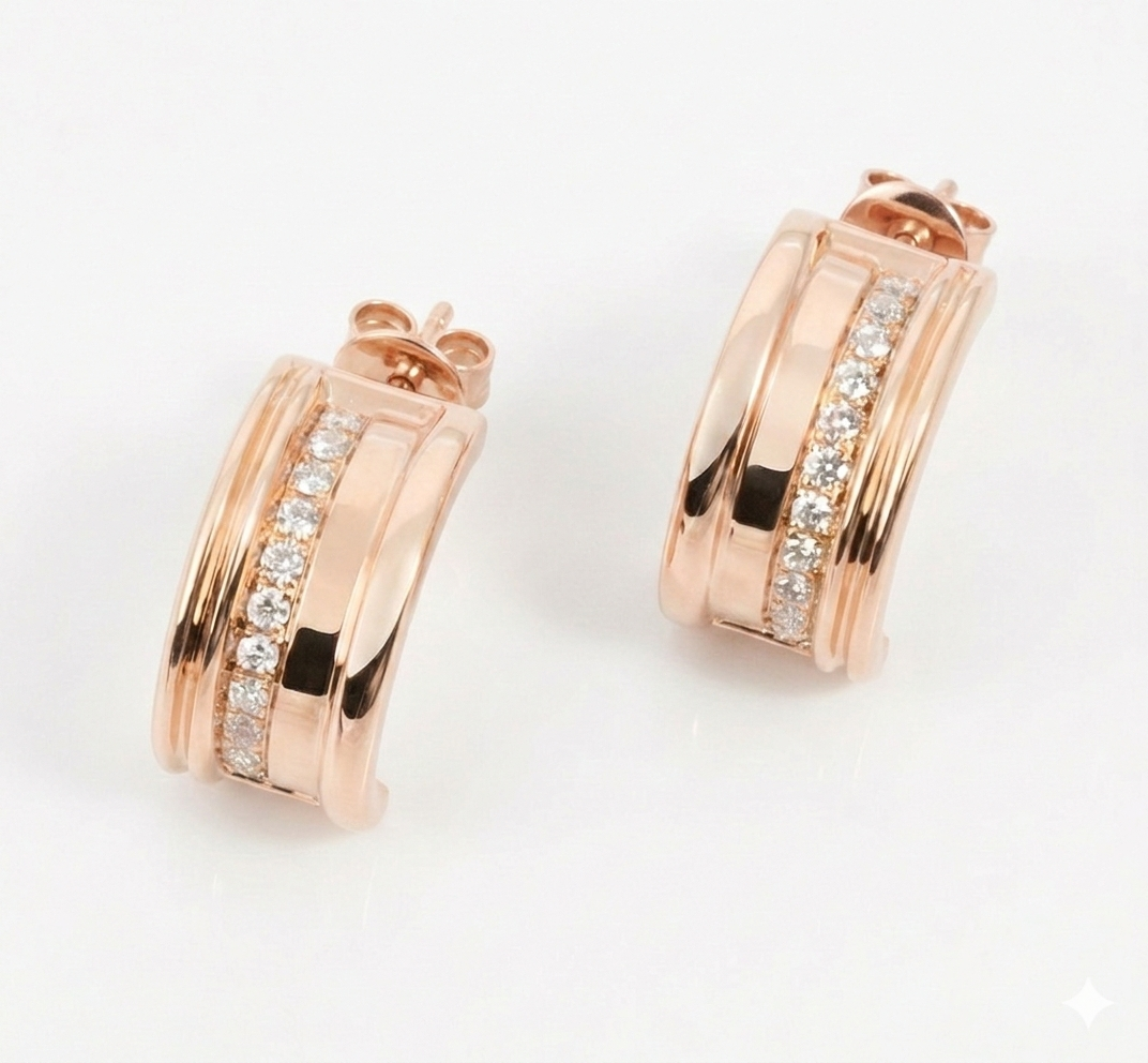 Rose gold hoop earrings with diamond accents on a light gray background