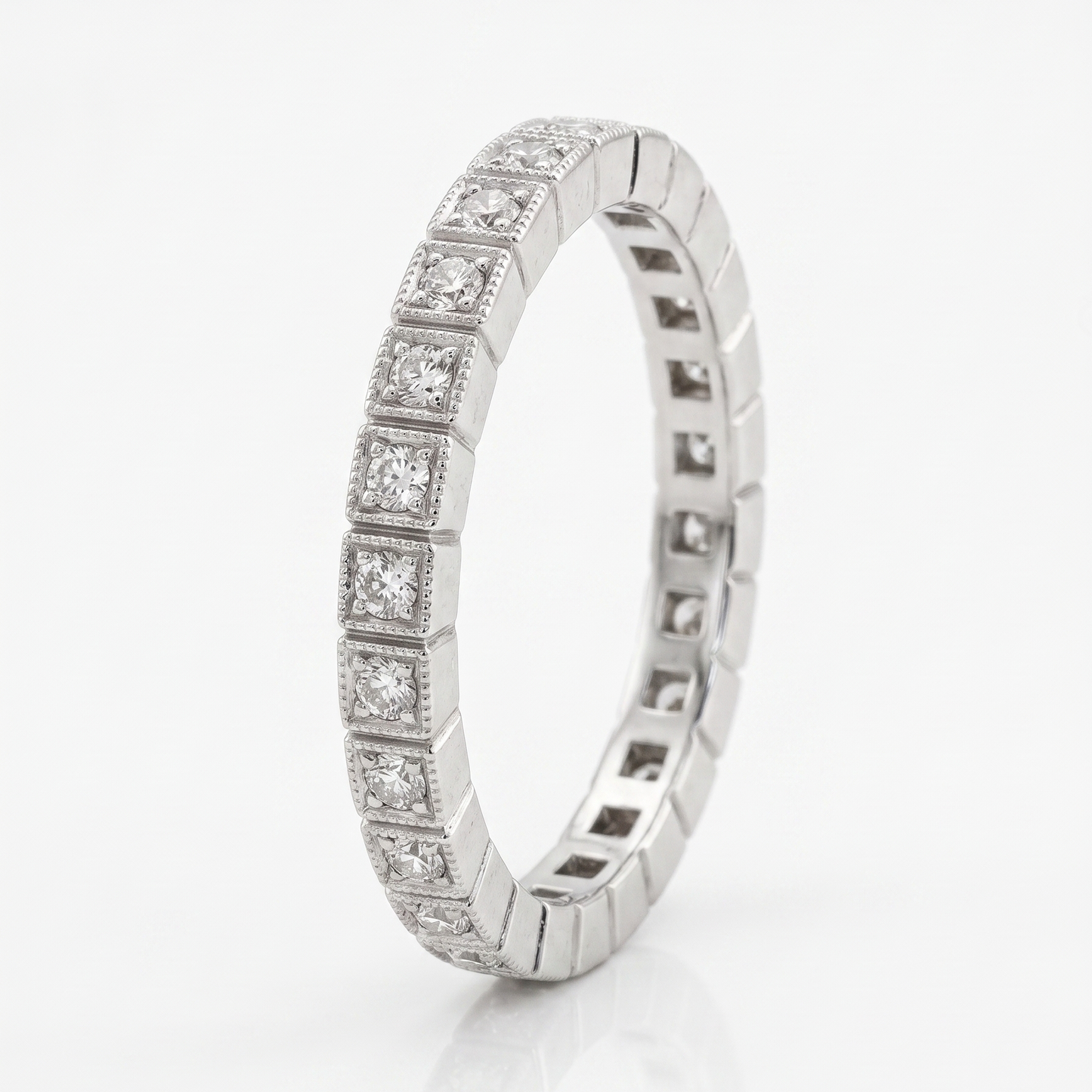 Silver ring with embedded diamonds on a white background