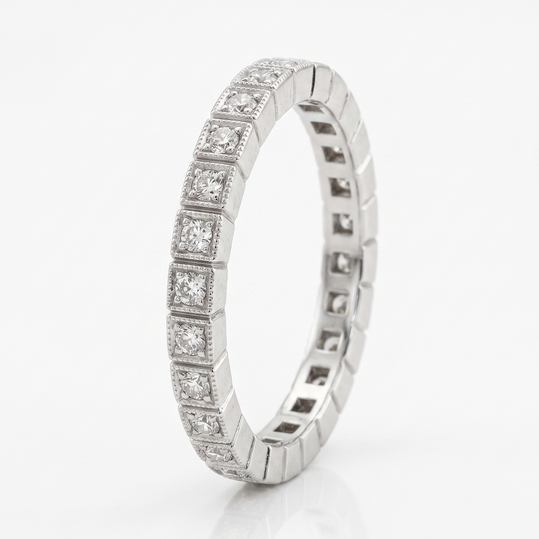 Silver ring with embedded diamonds on a white background