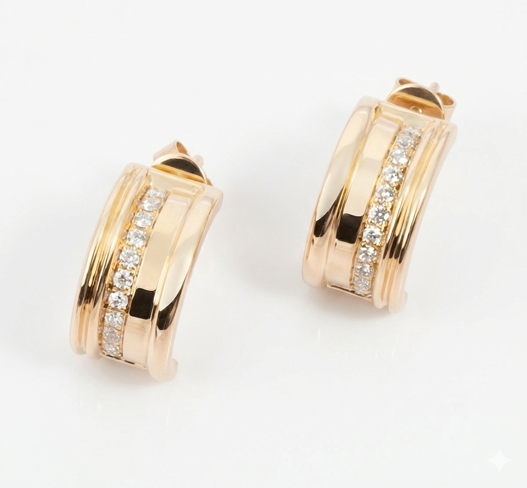 a pair for yellow gold white diamond hoop earrings on a white background