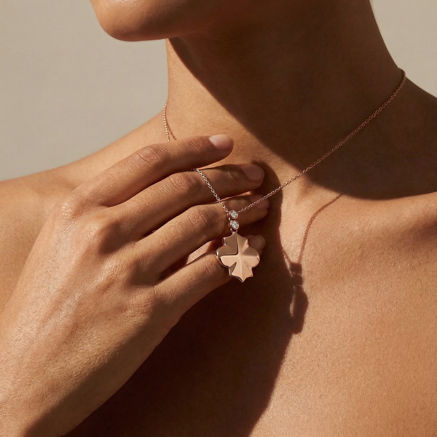 rose gold geometrical shape necklace with a chain a close up image on a model 
