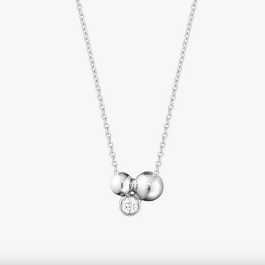 Silver necklace with two round pendants on a white background
