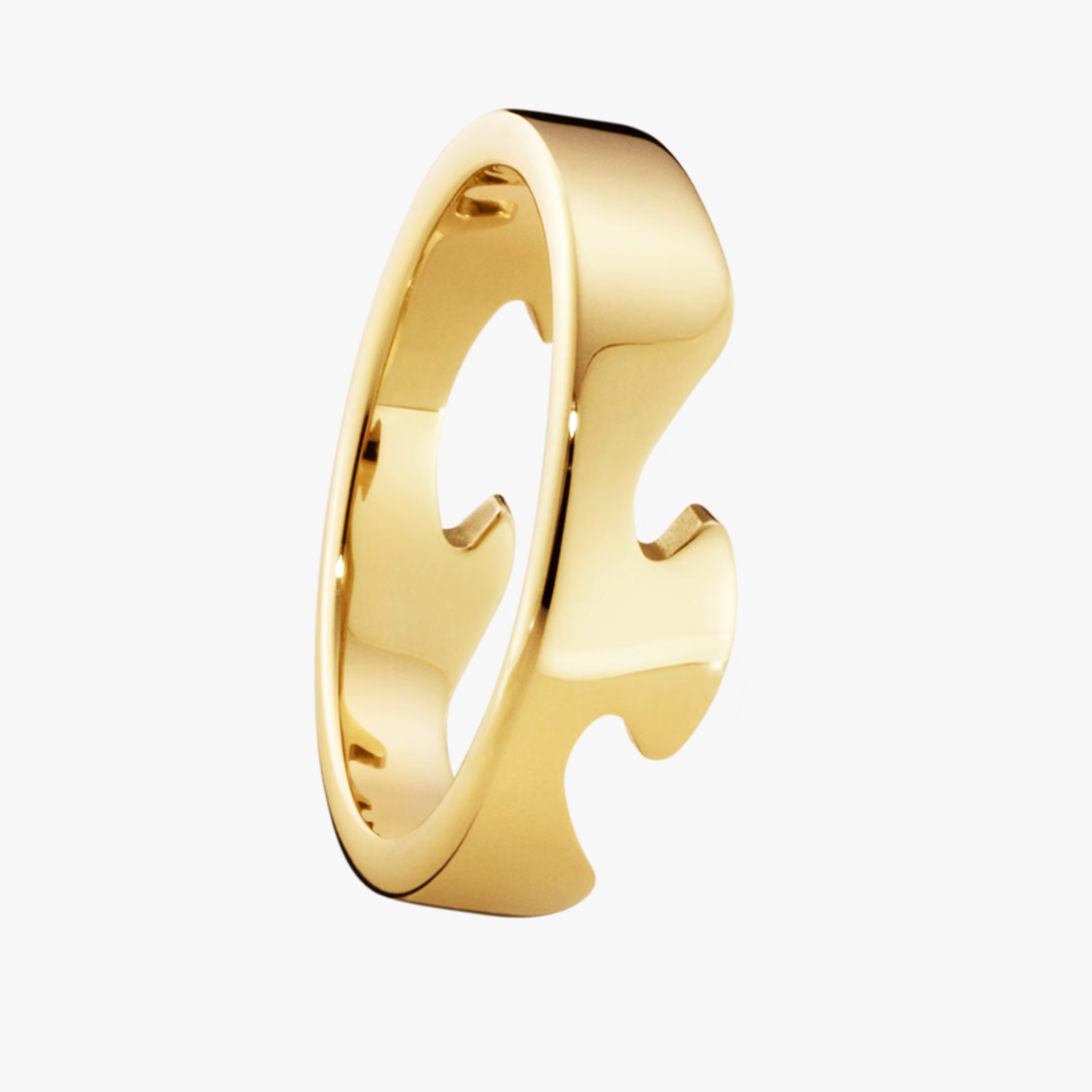 Gold puzzle piece ring on a white background