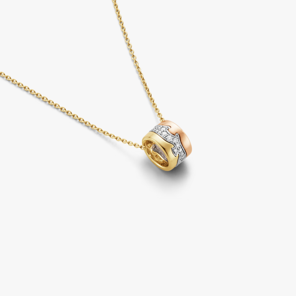 Gold necklace with a heart-shaped pendant on a white background