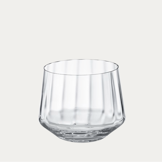 Clear glass tumbler on a light gray background