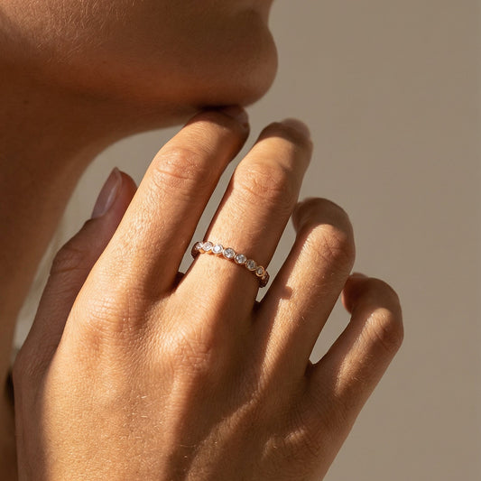 a close up image of a white diamond bubble ring on a models hand 