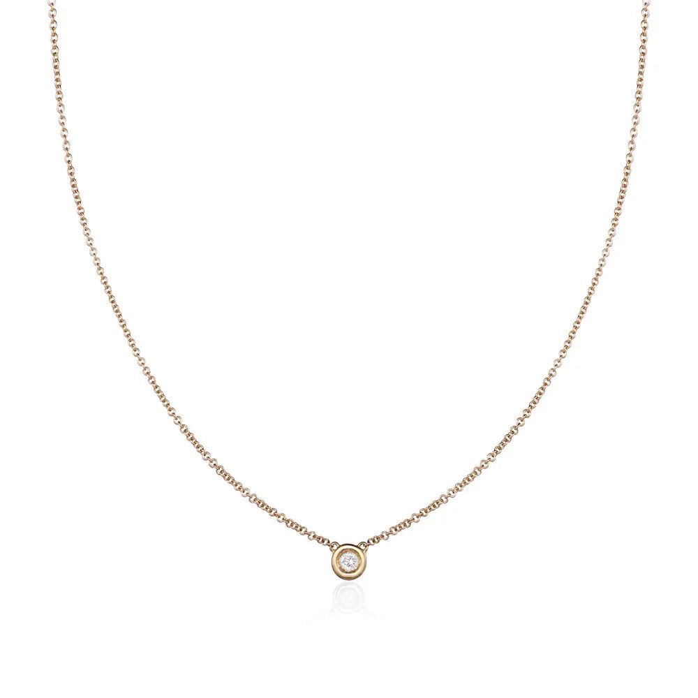 single diamond yellow gold necklace on a white background