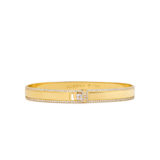 A gold bangle bracelet with pavé-set clear stones along the outer edges and a central square cluster of stones, shown on a plain white background. The inside of the bracelet is engraved with 'ALESSA 14K'.
