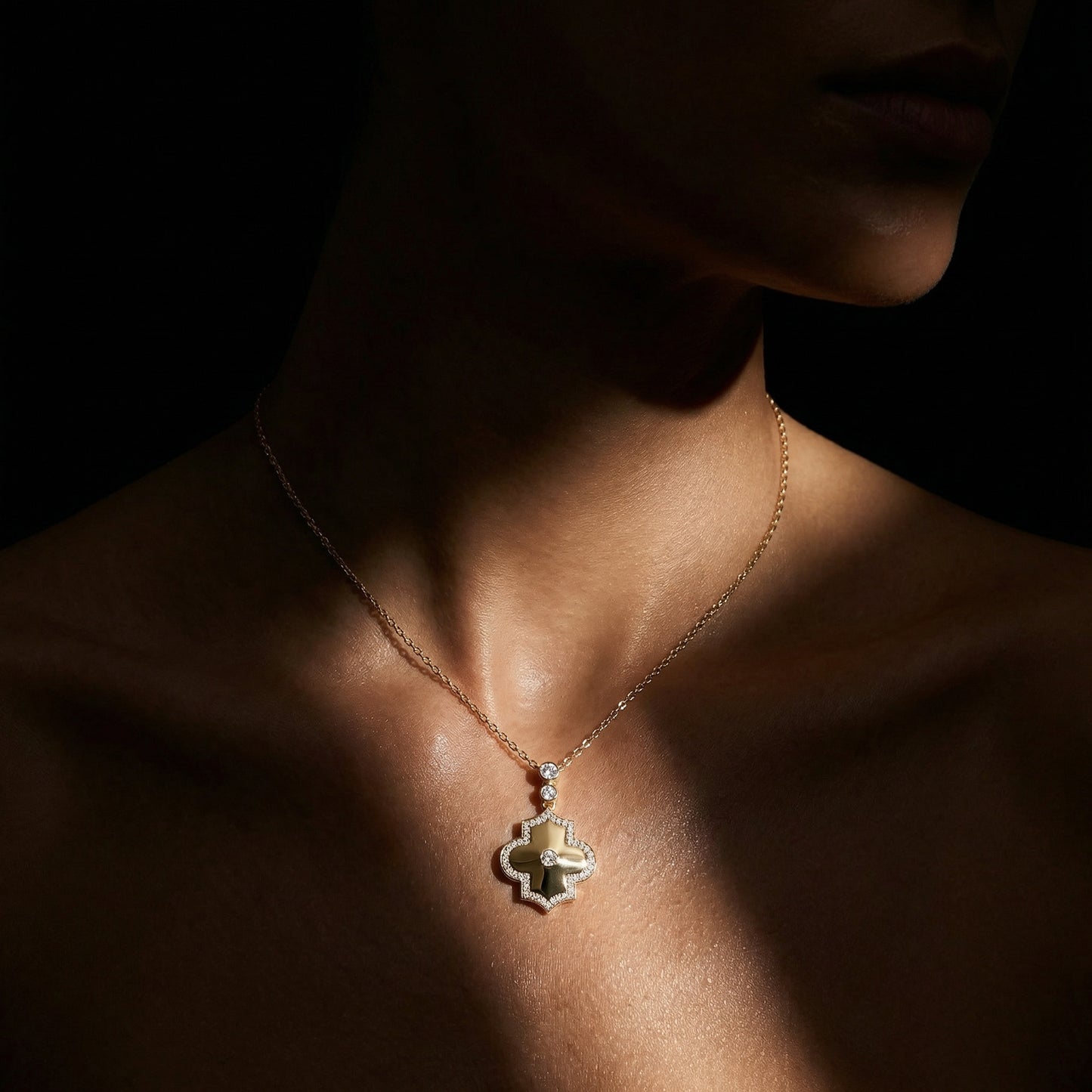 Necklace with a pendant worn by a person against a dark background