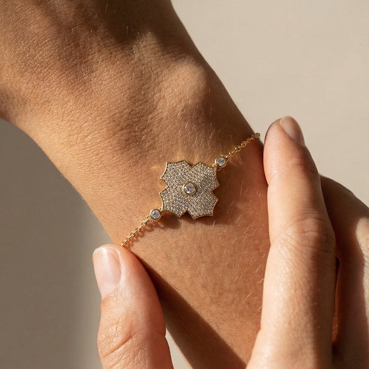 yellow gold pave diamond chain bracelet on a models hand 
