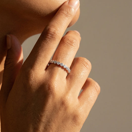 white gold white diamond bubble ring on a models hand 