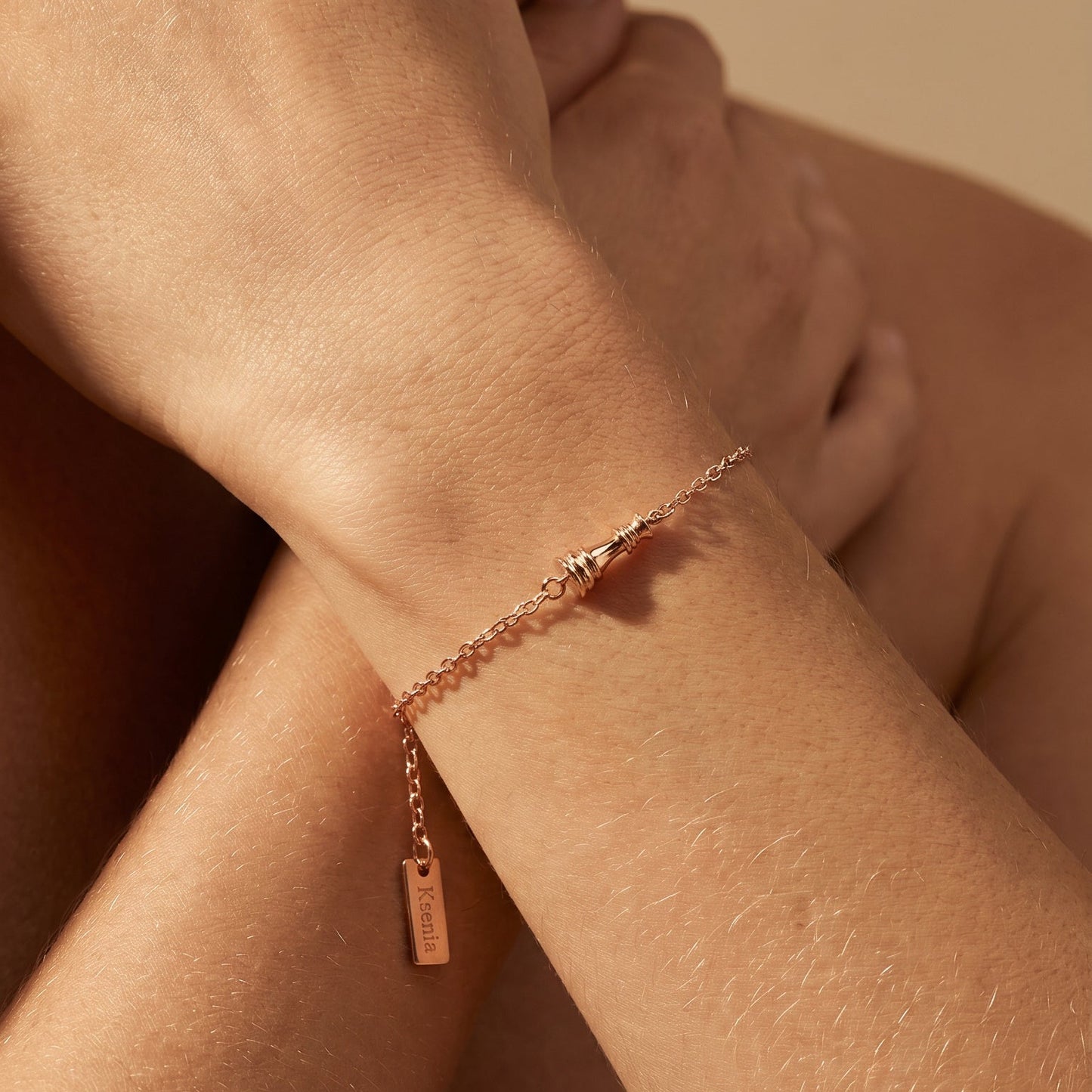 Ksenia Mirella Jewllery Queen Collection Rose gold bracelet on a person's wrist with a soft beige background