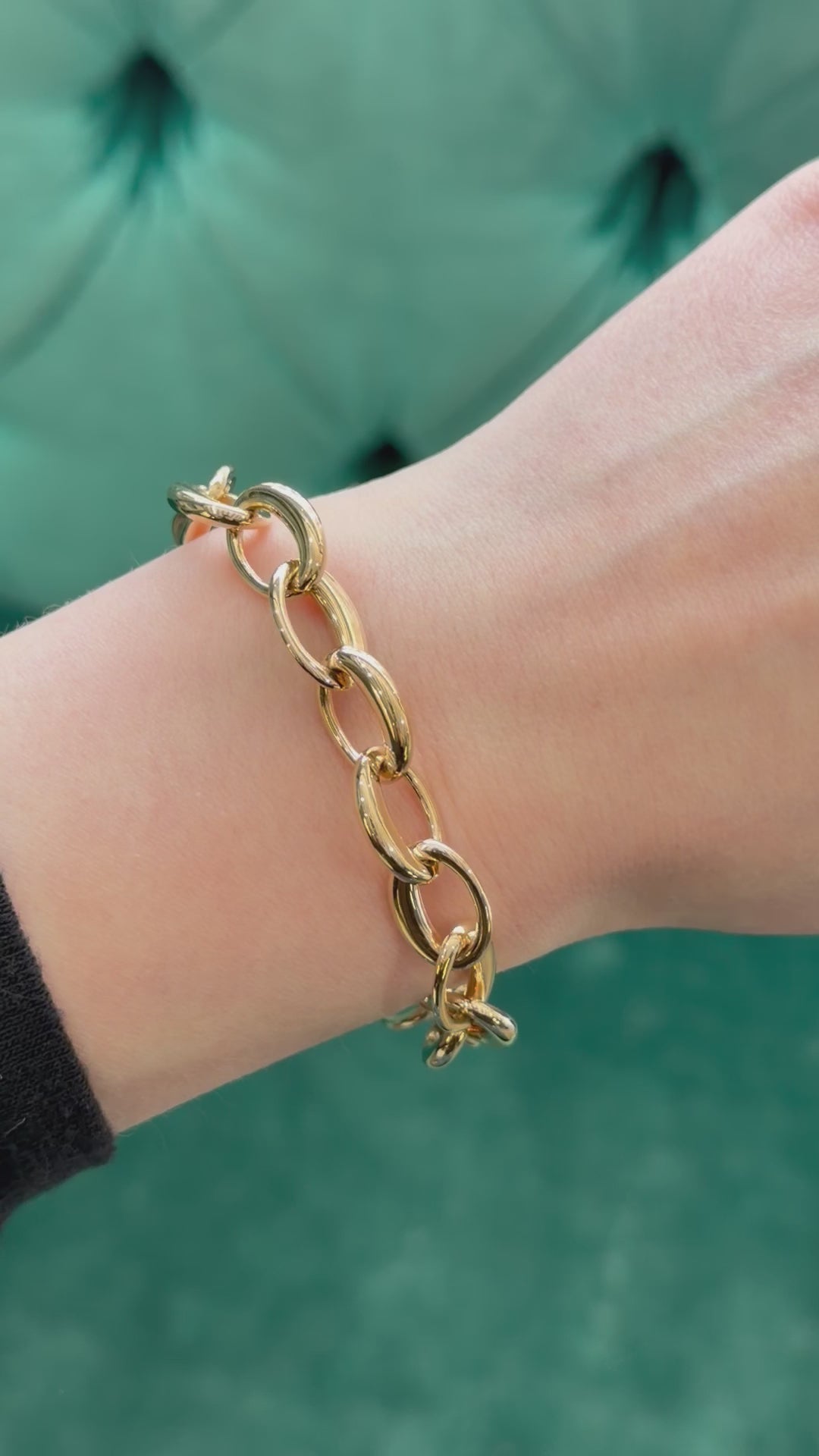 a gold bracelet on a models hand 