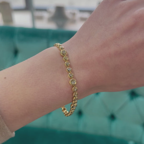 models haand showcasing a yellow gold diamond bubble bracelet 