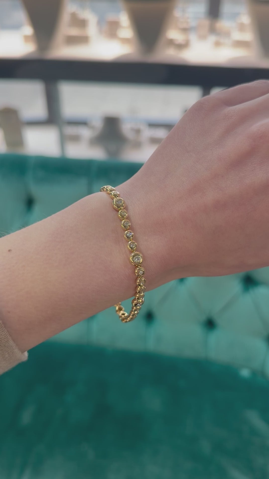 models haand showcasing a yellow gold diamond bubble bracelet 