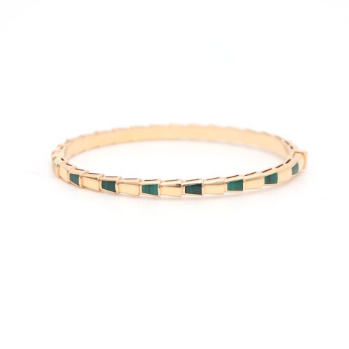 A gold Bvlgari serpenti bracelet featuring a row of small rectangular green inlay stones, photographed on a clean white background.
