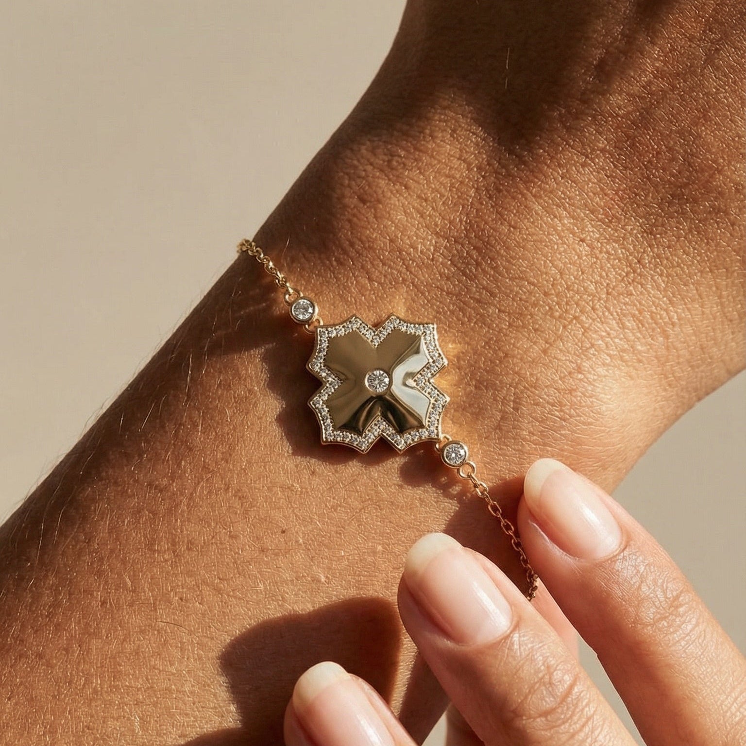 yellow gold white diamond chain bracelet on models hand  
