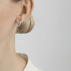 Georg Jensen mercy silver swirl earrings on a model