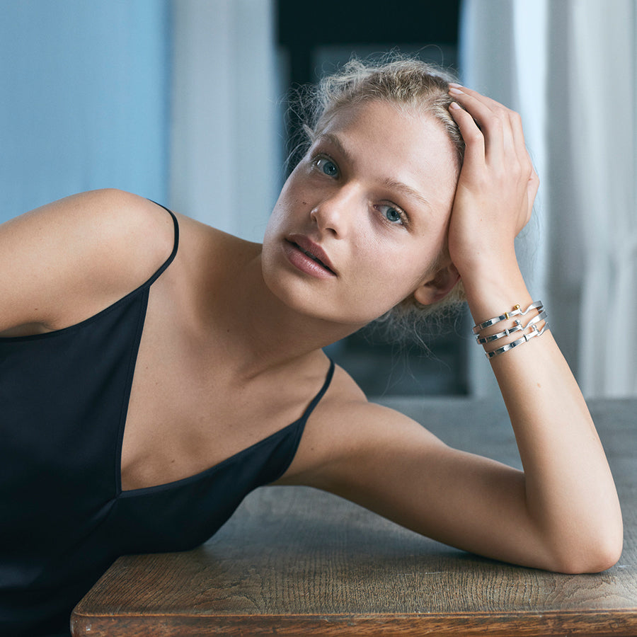 Georg Jensen Silver And 18ct Gold Torun Bangle worn on a model